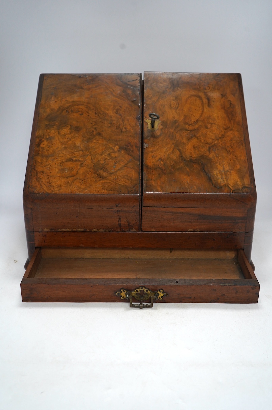 A Victorian burr walnut stationery rack, with two glass inkwells and partial label to the interior, with key, 37cm wide. Condition - fair